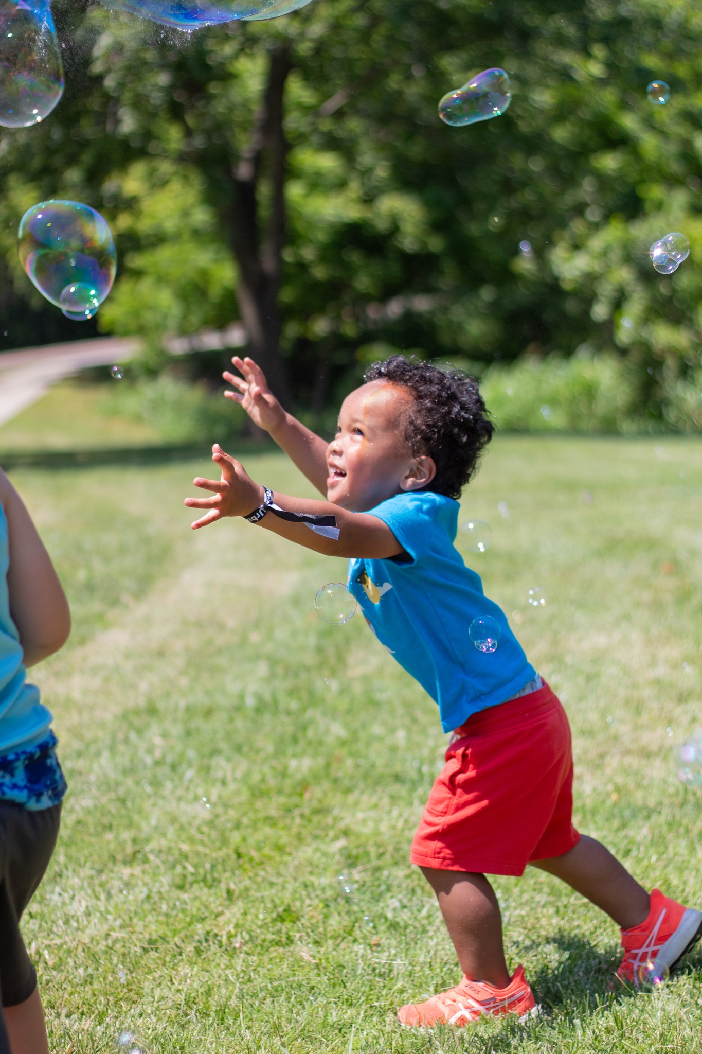 toddler chasing bubbles